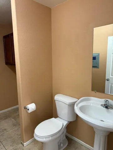 a white toilet sitting next to a bathroom sink