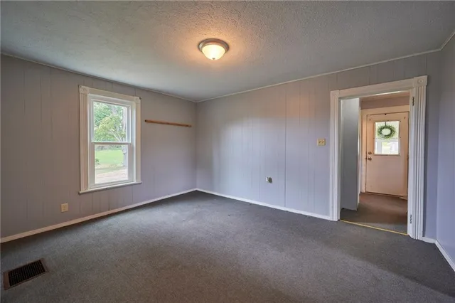 an empty room with windows and closet