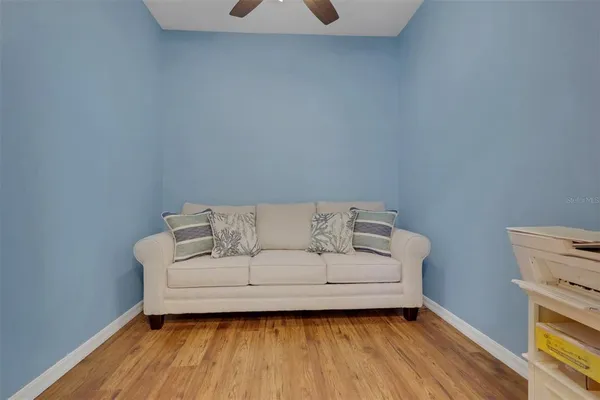a living room with a couch and a wooden floor