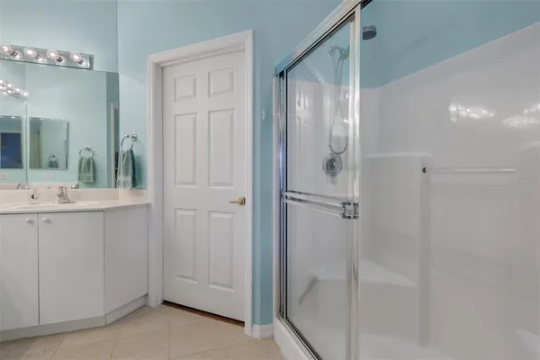 a bathroom with a shower and a sink