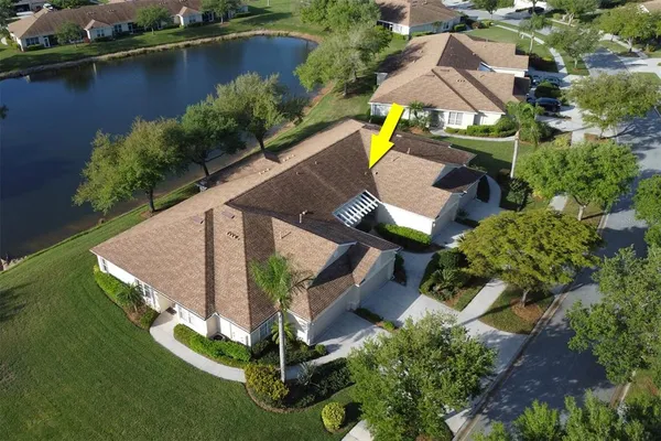 an aerial view of a house with swimming pool outdoor seating and yard