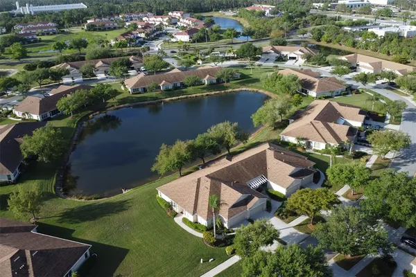 an aerial view of residential houses with outdoor space and swimming pool