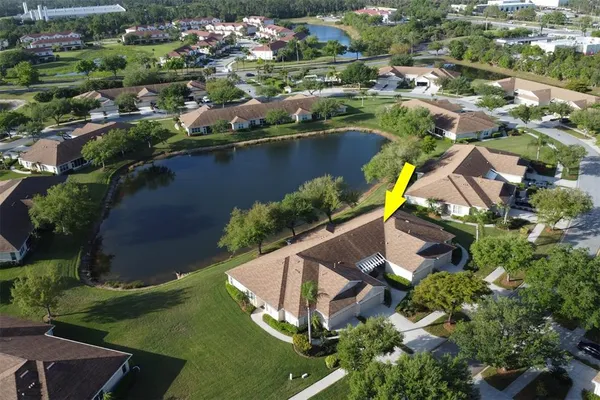 an aerial view of residential houses with outdoor space and swimming pool