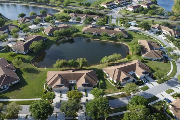 an aerial view of residential house with outdoor space and lake view