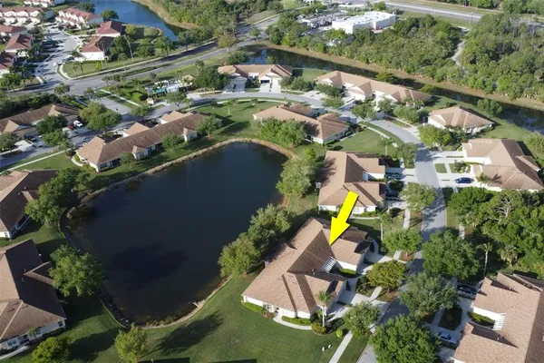 an aerial view of a house with a yard and outdoor seating