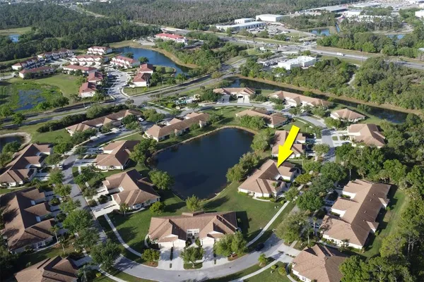 an aerial view of residential houses with outdoor space and swimming pool