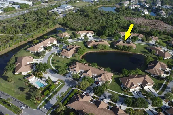 an aerial view of a house with a swimming pool yard and outdoor seating