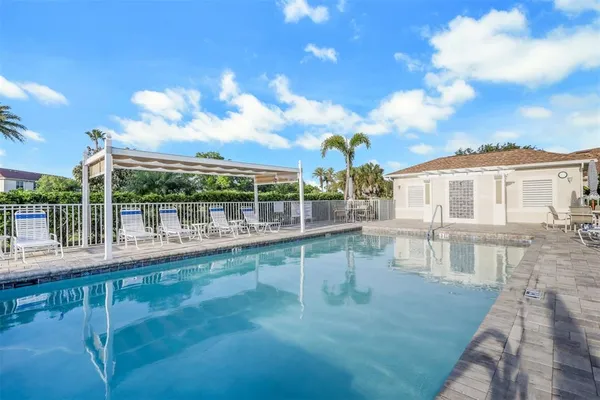 a view of a swimming pool with a patio and wooden floor