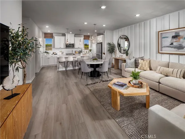 a living room with lots of furniture and kitchen view