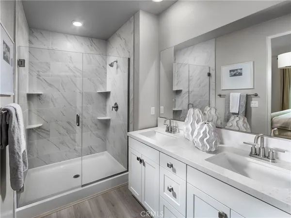 a bathroom with a shower sink and mirror