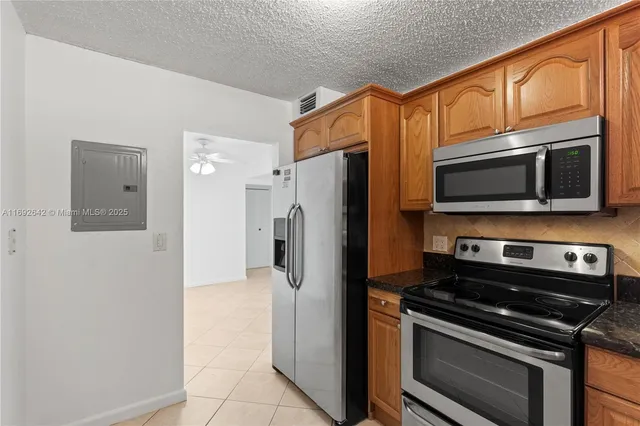 a kitchen with stainless steel appliances a refrigerator stove and microwave