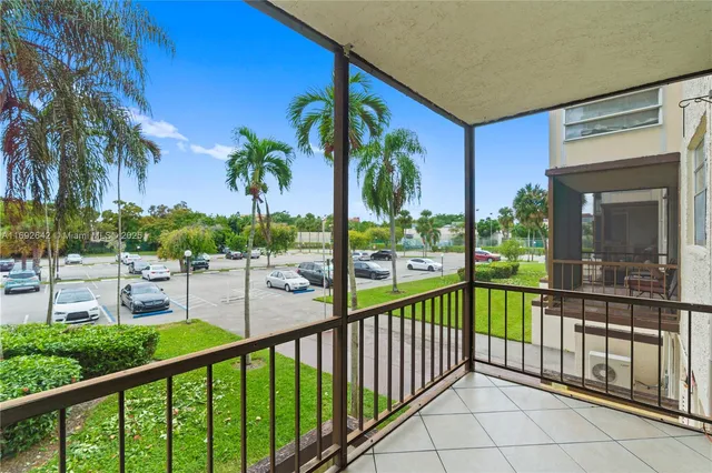a view of a palm trees from a balcony