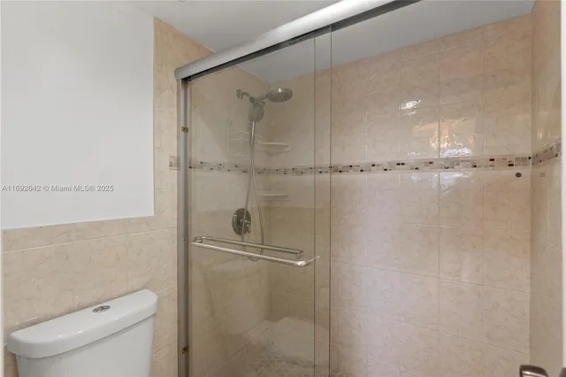 a bathroom with a shower and toilet