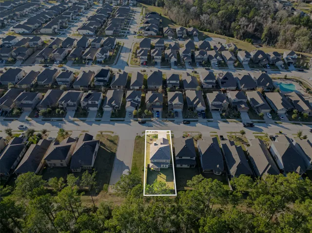 an aerial view of a house with a yard
