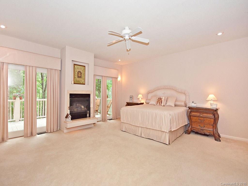 615 Brandywine Road Waynesville, NC 28786 - Photo 12 of 24 a spacious bedroom with a bed and a fireplace