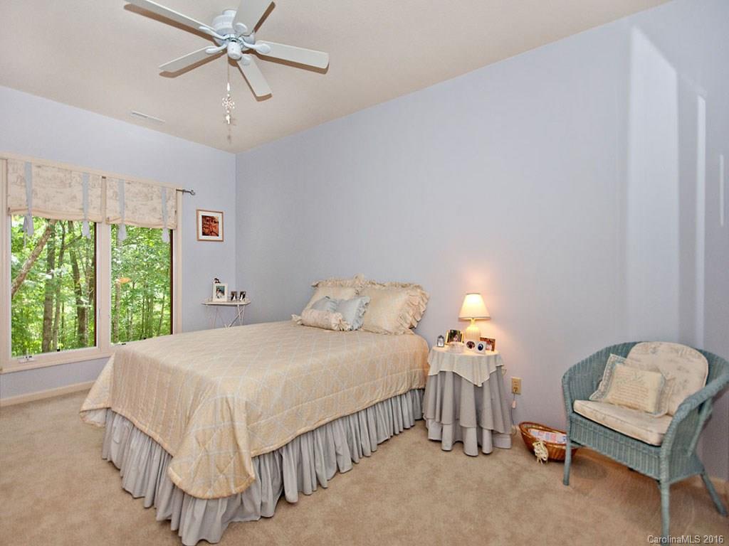 615 Brandywine Road Waynesville, NC 28786 - Photo 14 of 24 a bedroom with a bed and a chandelier