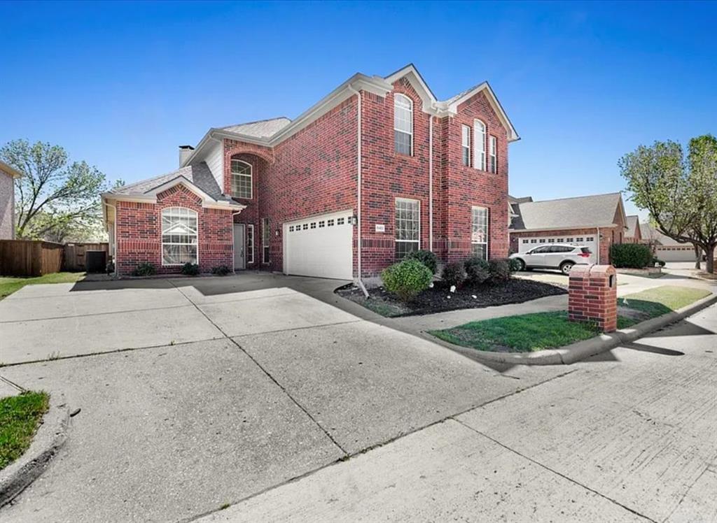 View of property exterior featuring brick siding, concrete driveway, and a garage