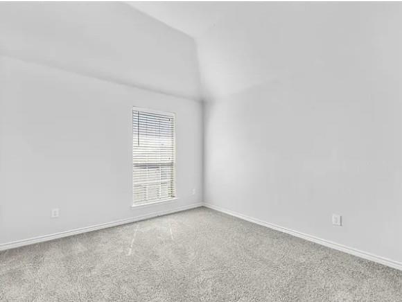 8401 Hitching Trail McKinney, TX 75070 - Photo 14 of 39 Carpeted spare room with baseboards and vaulted ceiling