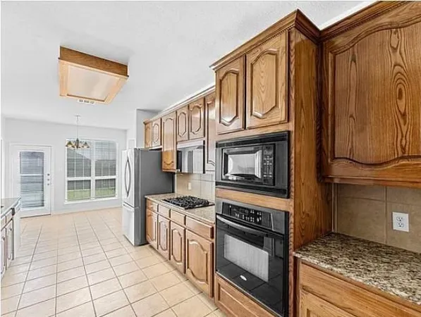 a spacious bathroom with a granite countertop sink and a mirror