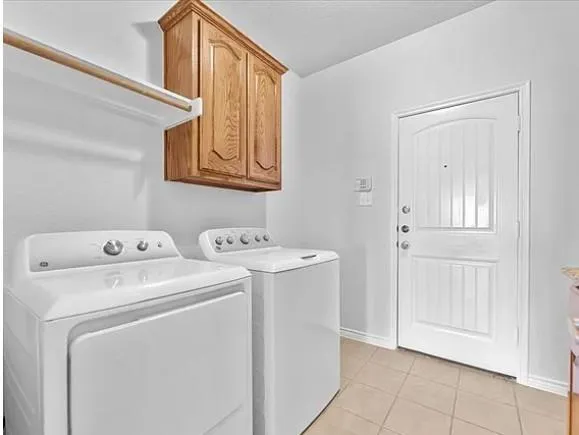 an empty room with wooden floor fireplace and windows