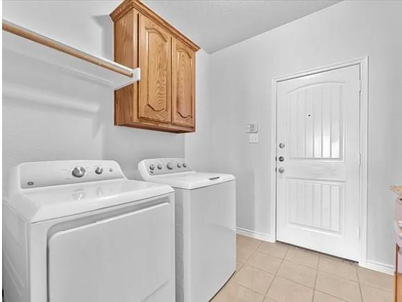 8401 Hitching Trail McKinney, TX 75070 - Photo 22 of 39 Laundry area featuring light tile patterned floors, cabinet space, and separate washer and dryer