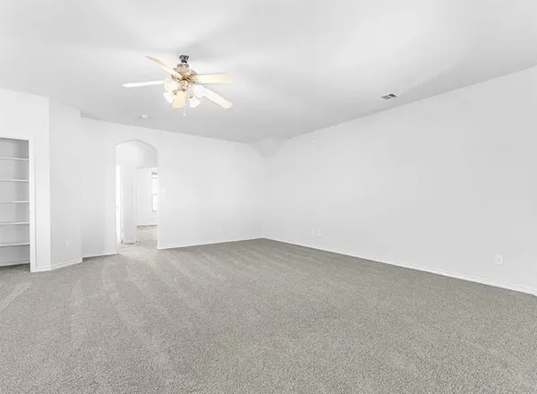a view of staircase with railing and white walls