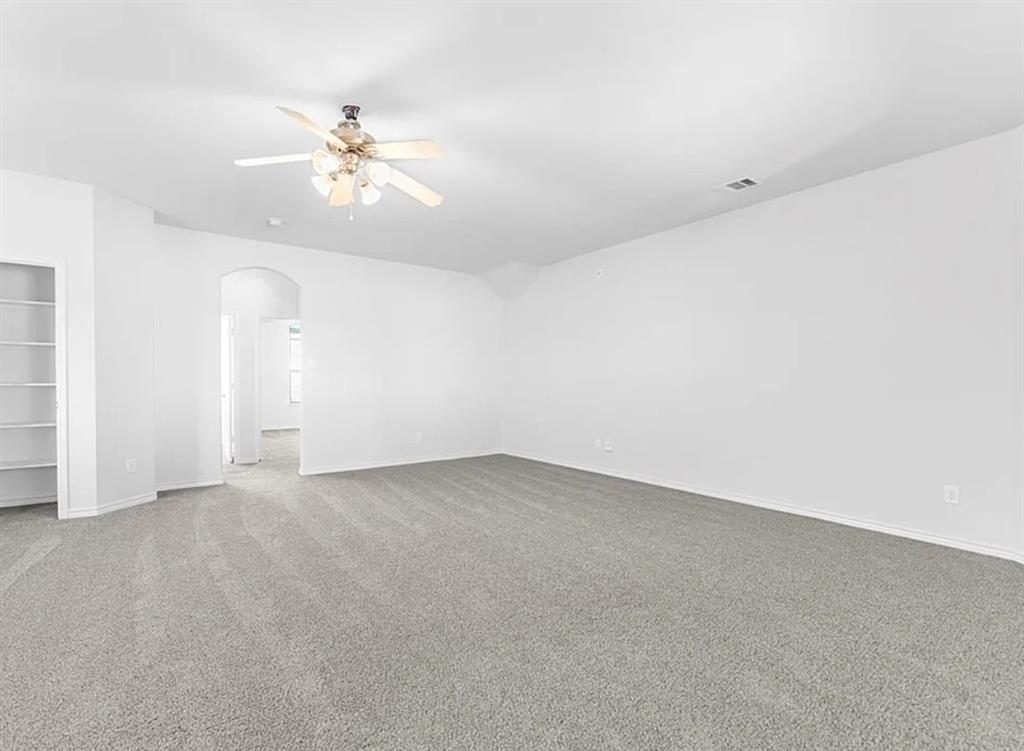 8401 Hitching Trail McKinney, TX 75070 - Photo 37 of 39 Unfurnished bedroom featuring arched walkways, light carpet, and a ceiling fan