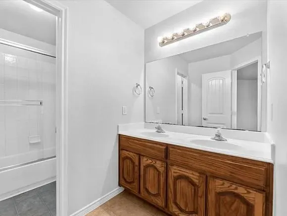 a bathroom with a double vanity sink and a mirror