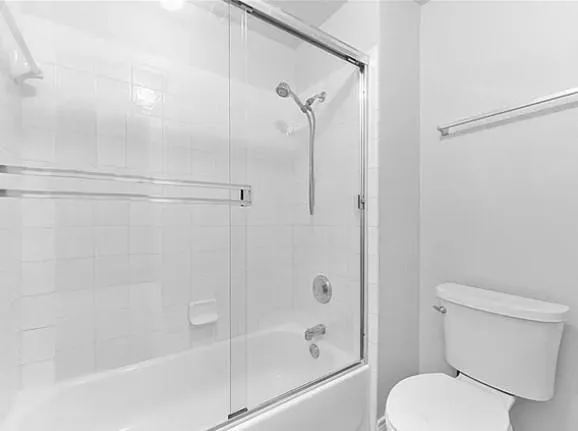 a bathroom with a shower and a toilet