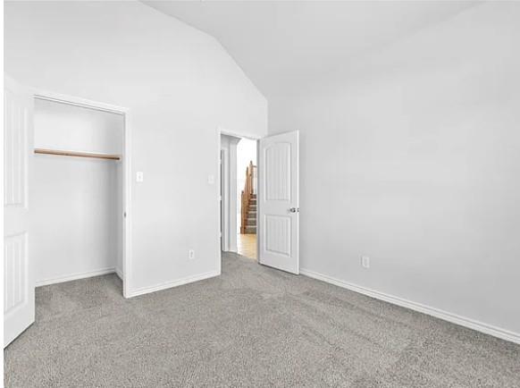 8401 Hitching Trail McKinney, TX 75070 - Photo 7 of 39 Unfurnished bedroom with carpet floors, a closet, and vaulted ceiling