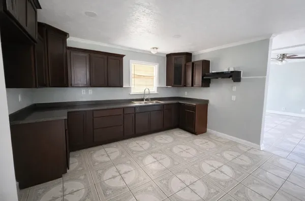 a kitchen with stainless steel appliances a sink and cabinets
