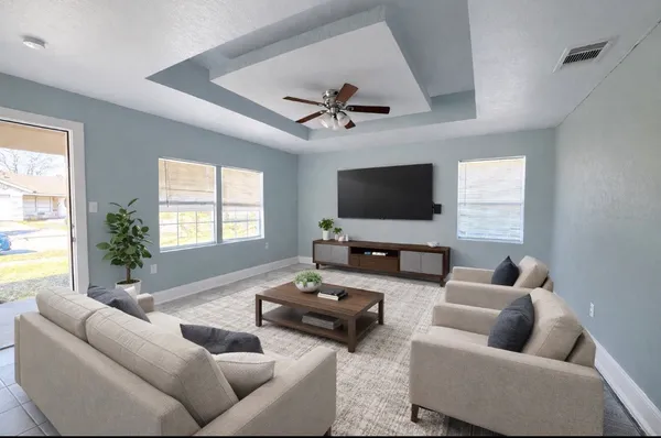 a living room with furniture and a flat screen tv