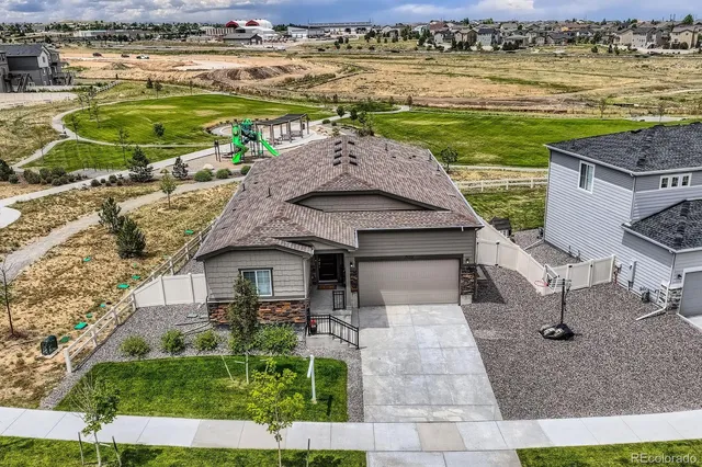 an aerial view of a house with a garden and lake view