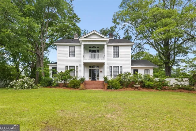 a front view of house with yard and green space