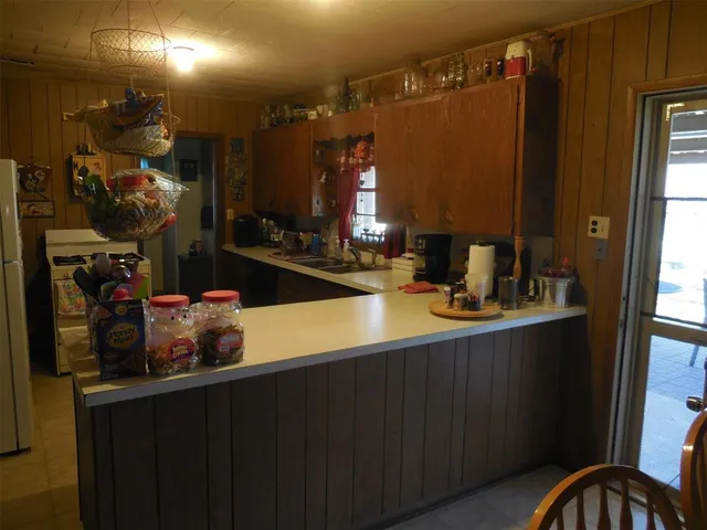 a bedroom with a bed and lamp with the dresser