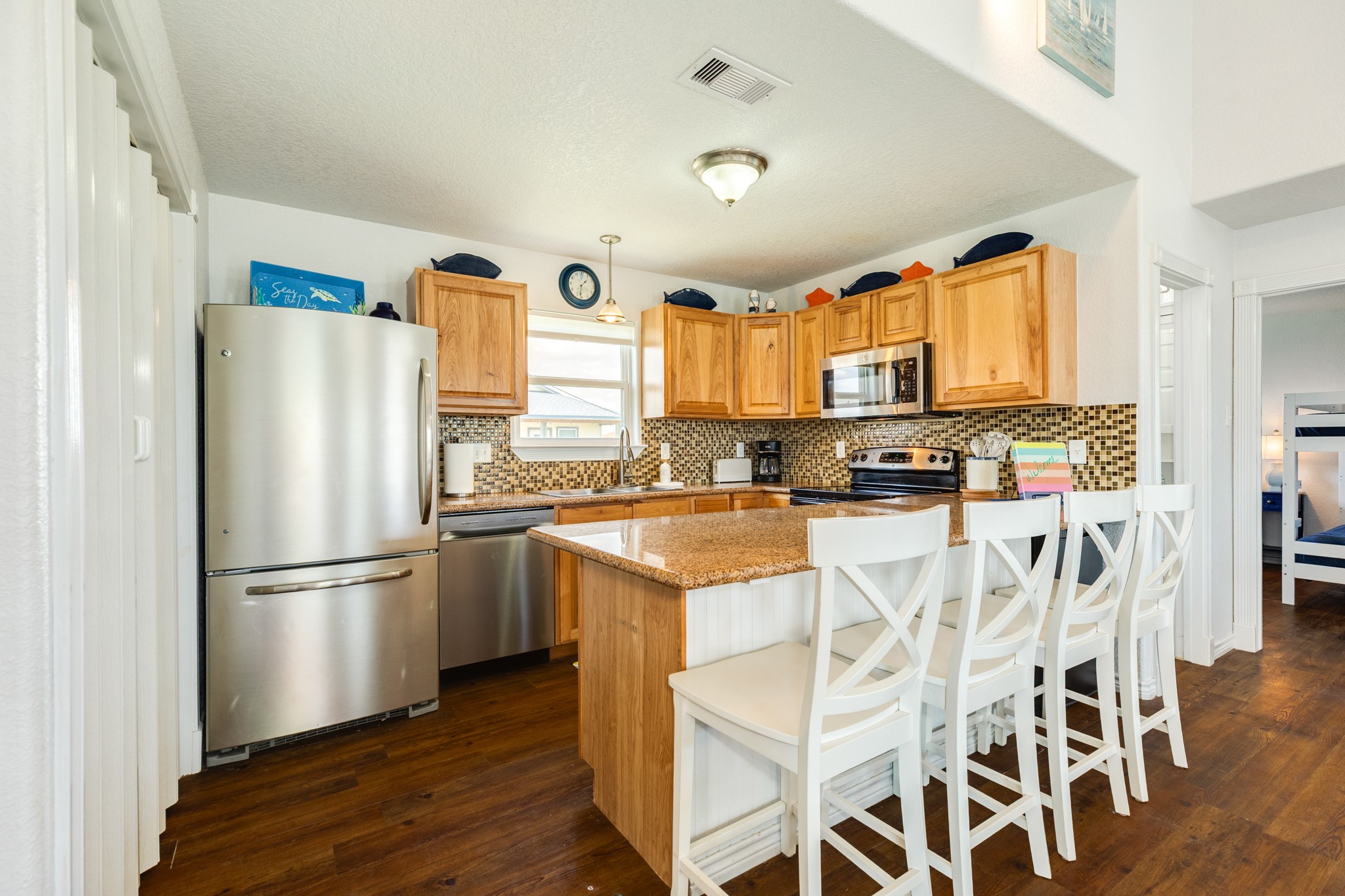 507 Point Lookout Surfside Beach, TX 77541 - Photo 17 of 31 a kitchen with stainless steel appliances granite countertop a refrigerator a stove a sink and a microwave