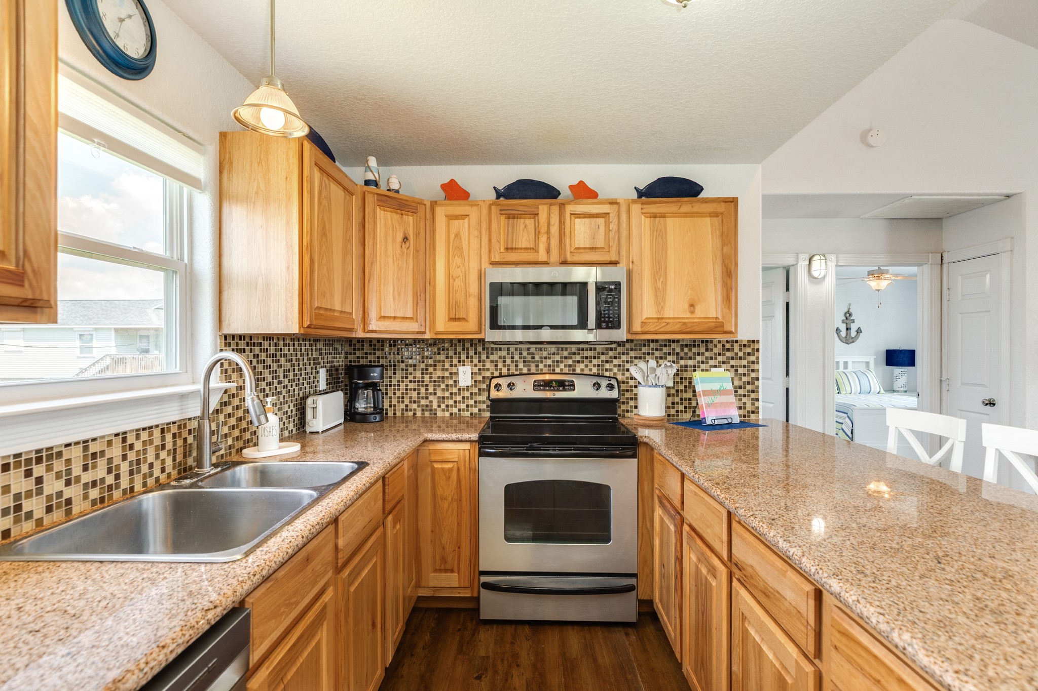 507 Point Lookout Surfside Beach, TX 77541 - Photo 18 of 31 a kitchen with granite countertop a sink a counter top space appliances and cabinets