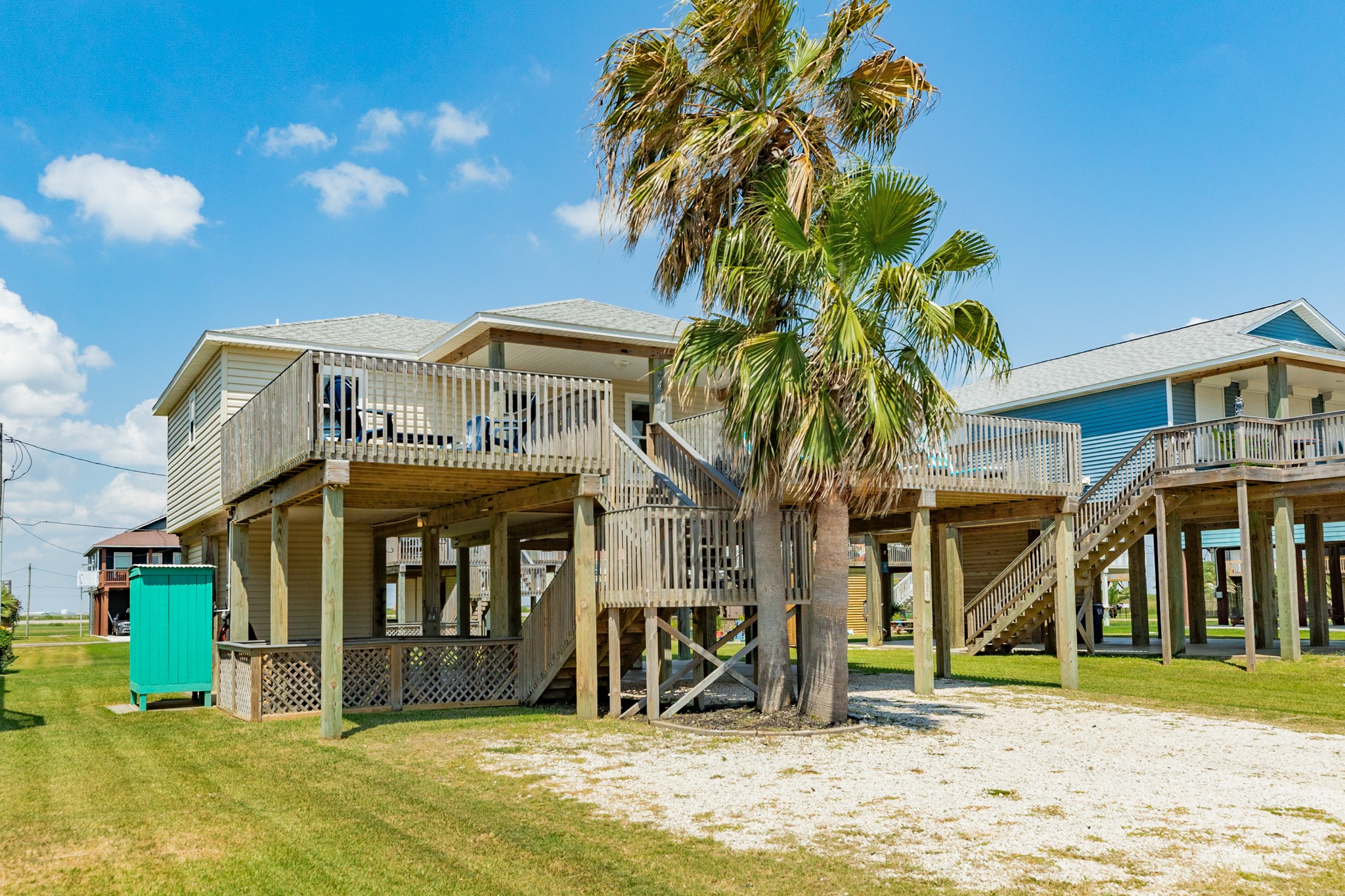 507 Point Lookout Surfside Beach, TX 77541 - Photo 2 of 31 a view of a white house with large windows and a yard