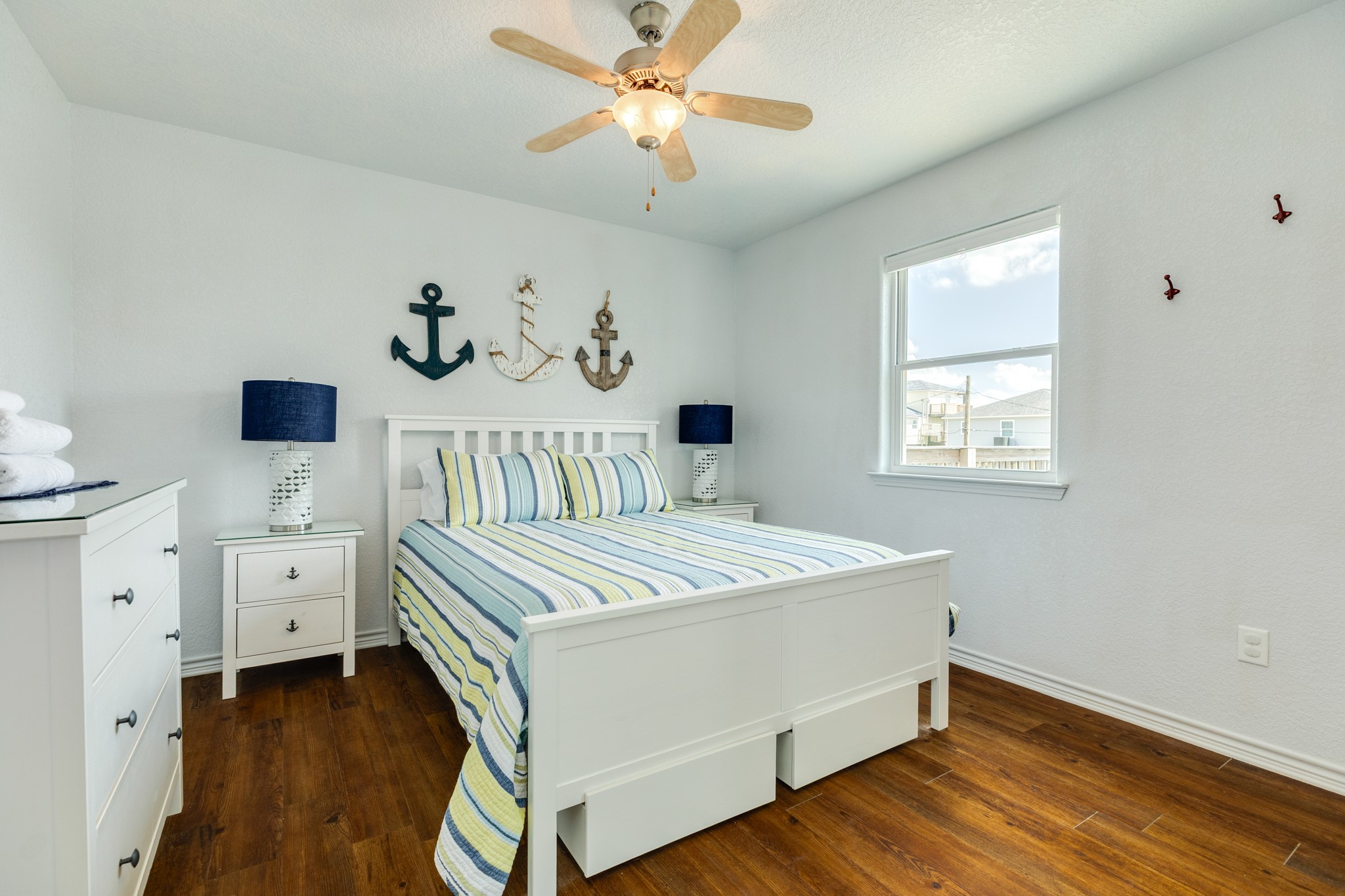 507 Point Lookout Surfside Beach, TX 77541 - Photo 21 of 31 a bedroom with a bed and a chandelier