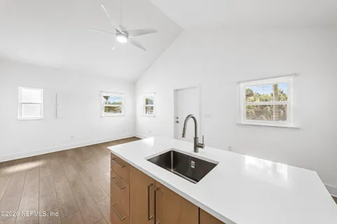 an empty room with wooden floor and window