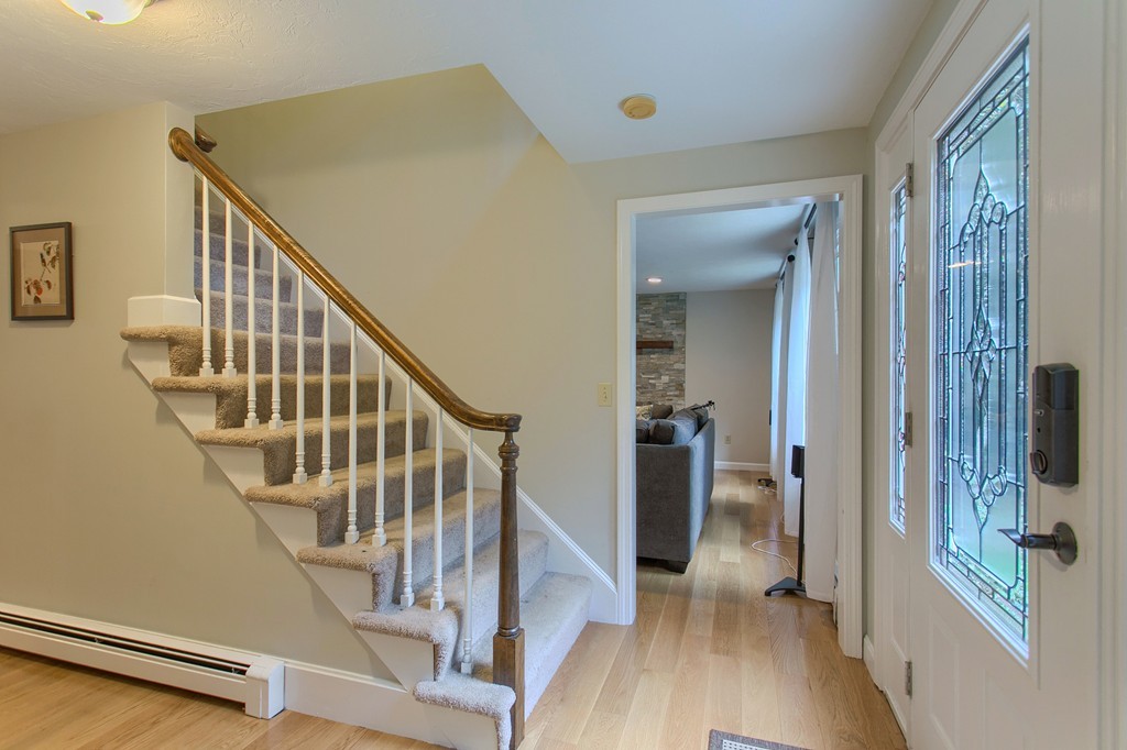 104 Sampson Road Bolton, MA 01740 - Photo 17 of 30 a view of a hallway with wooden floor and staircase