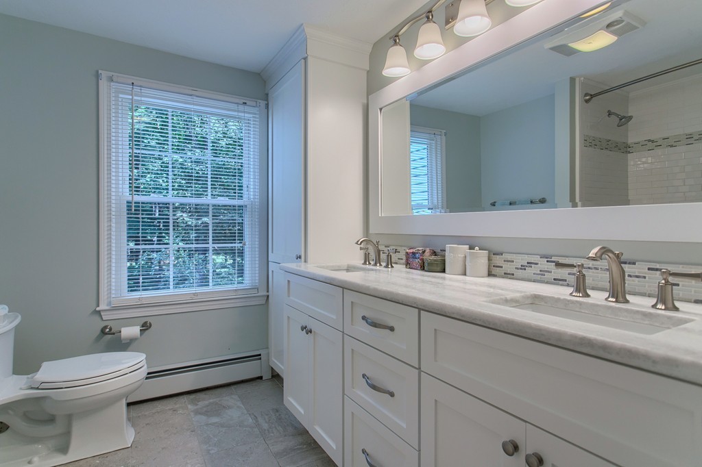104 Sampson Road Bolton, MA 01740 - Photo 19 of 30 a bathroom with a toilet a sink a mirror a window and vanity