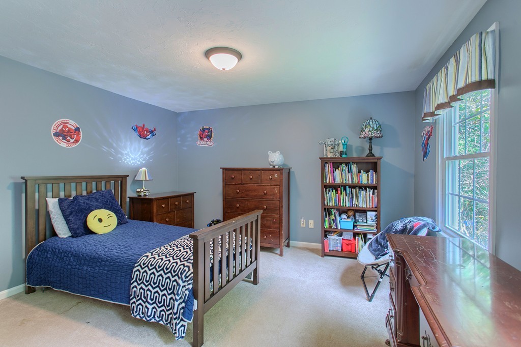 104 Sampson Road Bolton, MA 01740 - Photo 22 of 30 a living room with furniture and a bookshelf