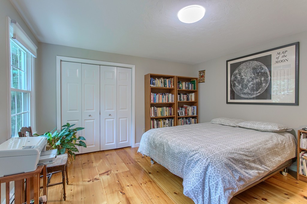 104 Sampson Road Bolton, MA 01740 - Photo 23 of 30 a bedroom with a bed and a potted plant