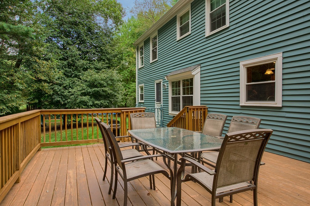 104 Sampson Road Bolton, MA 01740 - Photo 26 of 30 a view of a chairs and table on the deck