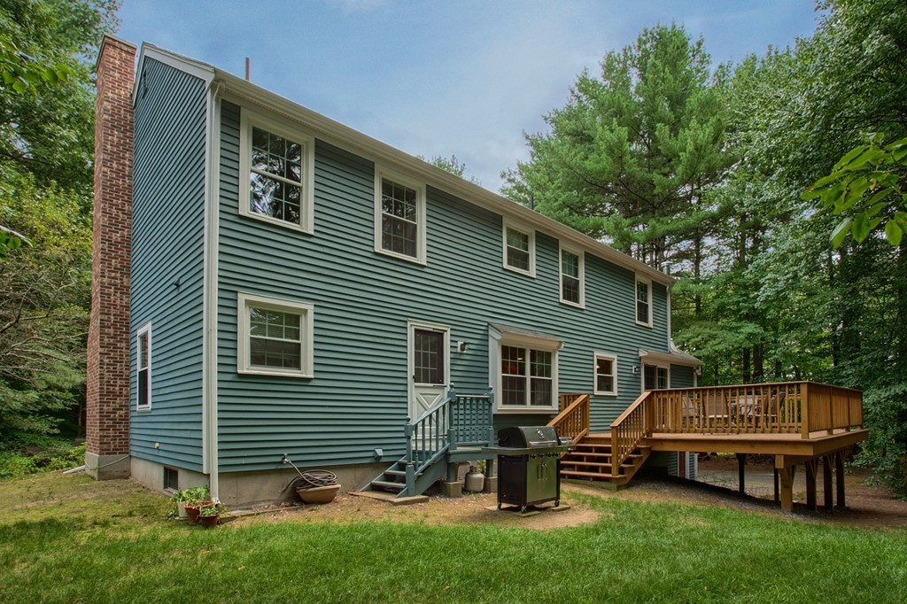 104 Sampson Road Bolton, MA 01740 - Photo 29 of 30 a backyard of a house with table and chairs