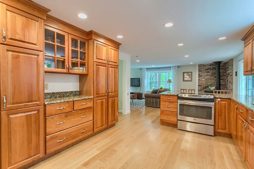 104 Sampson Road Bolton, MA 01740 - Photo 6 of 30 a kitchen with stainless steel appliances granite countertop a refrigerator and cabinets