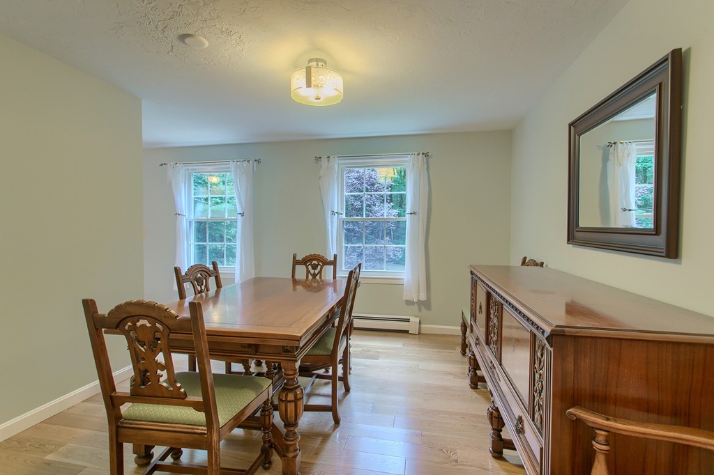 104 Sampson Road Bolton, MA 01740 - Photo 8 of 30 a view of a dining room with furniture and wooden floor