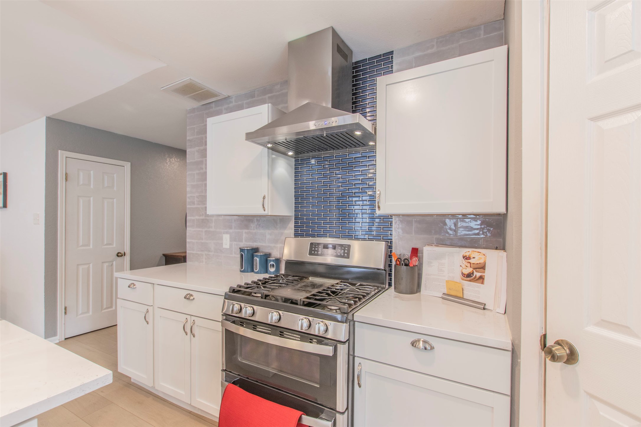 2400 Braemar Cove Austin, TX 78747 - Photo 7 of 20 a kitchen with stainless steel appliances granite countertop a stove and a refrigerator