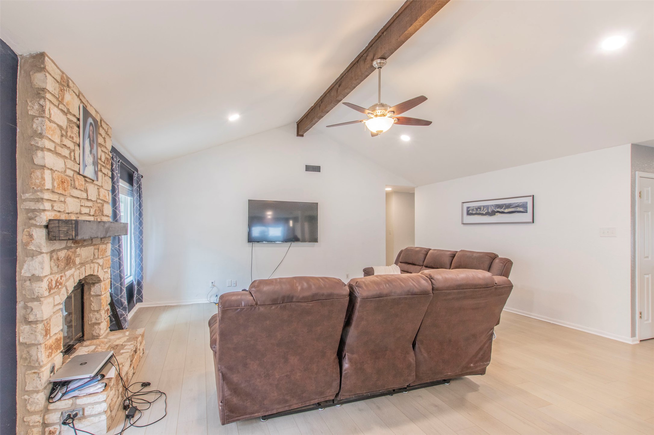 2400 Braemar Cove Austin, TX 78747 - Photo 10 of 20 a living room with furniture a ceiling fan and a fireplace